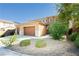 Charming two-story home with a two car garage and desert landscaping at 1633 Dornie Ave, North Las Vegas, NV 89084