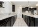 Modern kitchen with dark cabinetry, stainless appliances, and a white tile floor at 1633 Dornie Ave, North Las Vegas, NV 89084