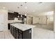 Open kitchen with granite countertops, dark wood cabinets, and a center island at 1633 Dornie Ave, North Las Vegas, NV 89084