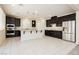 Spacious kitchen with dark cabinets, stainless appliances, and a large island at 1633 Dornie Ave, North Las Vegas, NV 89084