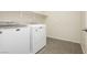 Functional laundry area includes a washer, dryer, and shelving for organized storage at 1633 Dornie Ave, North Las Vegas, NV 89084