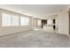 Large carpeted living room with a combined kitchen and dining area at 1633 Dornie Ave, North Las Vegas, NV 89084