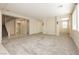 Open floor plan living room with carpet flooring and natural light at 1633 Dornie Ave, North Las Vegas, NV 89084