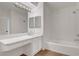 Modern bathroom with double mirrors, shower-tub combo and vanity with cabinets at 2050 N Los Feliz St # 171, Las Vegas, NV 89156