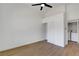 A well-lit bedroom with a ceiling fan, wood-style flooring and a closet with sliding doors, plus washer/dryer at 2050 N Los Feliz St # 171, Las Vegas, NV 89156