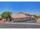 Exterior shot showcasing a well-maintained home with a tile roof and mature trees at 2050 N Los Feliz St # 171, Las Vegas, NV 89156