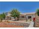 Charming home with a well-maintained front yard, mature tree, and stone accents enhancing curb appeal at 2050 N Los Feliz St # 171, Las Vegas, NV 89156