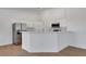 An open kitchen with modern stainless steel appliances, white cabinets and a breakfast bar at 2050 N Los Feliz St # 171, Las Vegas, NV 89156