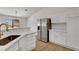 A contemporary kitchen with stainless steel appliances, white cabinetry, and marble countertops at 2050 N Los Feliz St # 171, Las Vegas, NV 89156