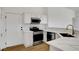 The modern kitchen features stainless steel appliances, white cabinets, a marble countertop, and wood-style floors at 2050 N Los Feliz St # 171, Las Vegas, NV 89156