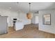 An open layout featuring the kitchen, dining, and living spaces with modern fixtures and plank flooring throughout at 2050 N Los Feliz St # 171, Las Vegas, NV 89156