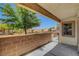 Outdoor patio featuring a brick wall and views of nearby houses, providing a relaxing space at 2050 N Los Feliz St # 171, Las Vegas, NV 89156