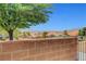 A mountain view, a brick wall, and greenery create an outdoor oasis at 2050 N Los Feliz St # 171, Las Vegas, NV 89156
