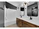 Modern bathroom features a double sink vanity and shower over tub combination with white tile surround at 21 Rue De Degas, Henderson, NV 89074
