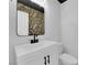 Stylish powder room with floral wallpaper, modern vanity, and sleek fixtures at 21 Rue De Degas, Henderson, NV 89074