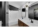 Modern bathroom with double sinks, wood vanities, and a shower-tub combination at 21 Rue De Degas, Henderson, NV 89074