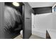 This modern bathroom showcases a toilet, shower over tub, and striking black and white wallpaper at 21 Rue De Degas, Henderson, NV 89074