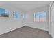 Bright, minimalist bedroom with neutral carpet and three windows for natural light at 21 Rue De Degas, Henderson, NV 89074