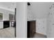 Mud room with built-in storage and shoe racks, adjacent to a modern kitchen at 21 Rue De Degas, Henderson, NV 89074