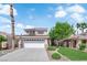 Charming two-story home with a well-manicured lawn and a two-car garage at 21 Rue De Degas, Henderson, NV 89074