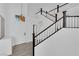 Bright foyer featuring a staircase, white walls, and modern lighting fixtures at 21 Rue De Degas, Henderson, NV 89074