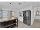 Contemporary kitchen with stainless steel refrigerator, open shelving, and modern lighting at 21 Rue De Degas, Henderson, NV 89074