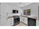 Bright kitchen featuring white cabinets, stainless steel appliances, and a window view at 21 Rue De Degas, Henderson, NV 89074