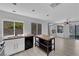 Open-concept kitchen with an island, stainless steel appliances, and large windows at 21 Rue De Degas, Henderson, NV 89074