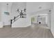 Bright living room with gray wood floors, modern lighting, stairs and a high ceiling at 21 Rue De Degas, Henderson, NV 89074