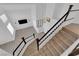 View from the stairs to the open floor plan living room with wood flooring and plenty of natural light at 21 Rue De Degas, Henderson, NV 89074