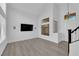 Bright living room with wood floors, high ceilings, and modern light fixtures at 21 Rue De Degas, Henderson, NV 89074