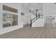 Bright living room showcasing a modern staircase and large windows with natural light at 21 Rue De Degas, Henderson, NV 89074