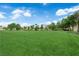 Expansive green open space providing recreational area with mature trees and blue skies in a well-maintained neighborhood at 21 Rue De Degas, Henderson, NV 89074