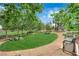 Community park with lush green lawn, artistic animal statues, benches, and shaded walkways in a lovely neighborhood at 21 Rue De Degas, Henderson, NV 89074