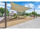 Community playground featuring a covered play area, seating, and green slide for outdoor fun and recreation at 21 Rue De Degas, Henderson, NV 89074