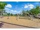 Community playground featuring a climbing structure, slides, and soft bark ground cover on a sunny day at 21 Rue De Degas, Henderson, NV 89074