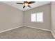 Cozy bedroom featuring a ceiling fan, neutral walls, and a large window with shutters at 2291 W Horizon Ridge Pkwy # 6131, Henderson, NV 89052