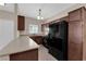 Kitchen featuring dark wood cabinets, stainless steel appliances, and light colored countertops at 2291 W Horizon Ridge Pkwy # 6131, Henderson, NV 89052