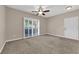 Neutral living room with a ceiling fan and sliding door to the outside at 2291 W Horizon Ridge Pkwy # 6131, Henderson, NV 89052
