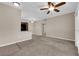 Living room with neutral walls, carpeted floors and a ceiling fan, next to an eat-in kitchen at 2291 W Horizon Ridge Pkwy # 6131, Henderson, NV 89052