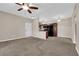 View of living room, showcasing neutral walls, carpeted floor, and a ceiling fan at 2291 W Horizon Ridge Pkwy # 6131, Henderson, NV 89052