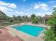 Community pool featuring a brick patio, blue water, lounge chairs, and greenery at 2291 W Horizon Ridge Pkwy # 6131, Henderson, NV 89052