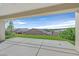 Covered back porch offers beautiful views of the green lawn and surrounding neighborhood homes at 2428 Hamonah Dr, Henderson, NV 89044