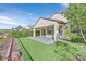 Home's artificial turf backyard with a covered patio area is the perfect low-maintenance outdoor space at 2428 Hamonah Dr, Henderson, NV 89044