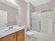 Clean bathroom featuring a shower-tub combo with a sliding door and a single sink vanity at 2428 Hamonah Dr, Henderson, NV 89044