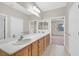 Bright bathroom features a double sink vanity with wood cabinets at 2428 Hamonah Dr, Henderson, NV 89044