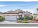 Charming single-story home featuring a well-maintained landscaped front yard and two-car garage at 2428 Hamonah Dr, Henderson, NV 89044