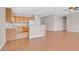 Open-concept kitchen and living area featuring wood cabinets, tile floors and appliances at 2428 Hamonah Dr, Henderson, NV 89044