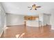 Open-concept living area with a view of the kitchen, wood floors and neutral tones at 2428 Hamonah Dr, Henderson, NV 89044