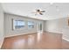 Bright living room featuring wood floors, a ceiling fan, and plenty of natural light at 2428 Hamonah Dr, Henderson, NV 89044